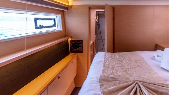 This Lagoon 560 Topaz cabin features a private bathroom and sea-view window for added comfort.