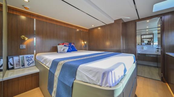 Evita power catamaran features a double bed, wooden interior design and direct access to a private bathroom.