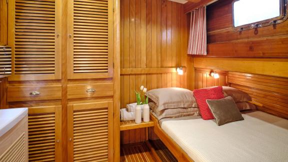 The guest cabin of White Pearl gulet in Athens features a double bed and spacious wardrobes.