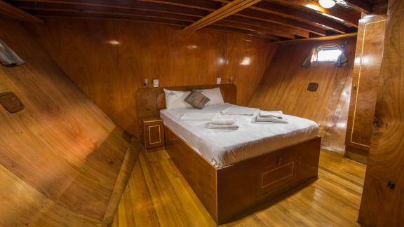 Cozy double cabin of Gulet Valerie with wooden paneling.