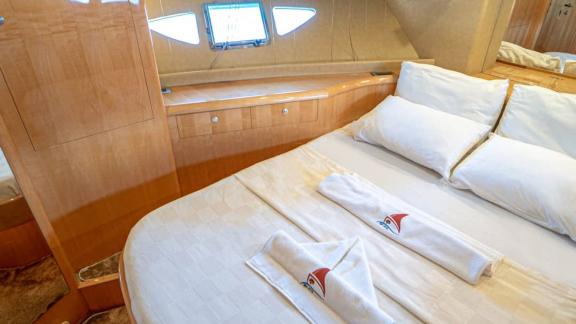 Comfortable master cabin of motor yacht İmera with large bed and storage space.