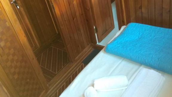 Passage from the cabin to the bathroom on Gulet Aurora with wooden elements.