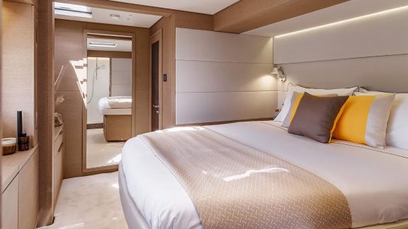 The sunlit cabin on the Catamaran Daiquiri offers luxurious comfort with a spacious bed, stylish design, and direct acce