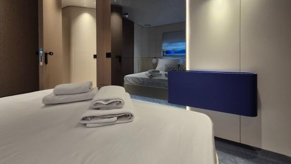 In Sibenik motor yacht charter option First Horizon cabin with bed and passage to another room visible.