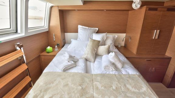 Comfortable cabin with double bed, soft pillows, and storage space on Lagoon 450F Adriatic Tiger