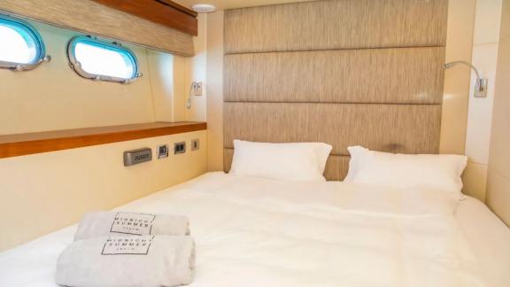 Comfortable double bed with sea view on the Midnight Summer Dream yacht.