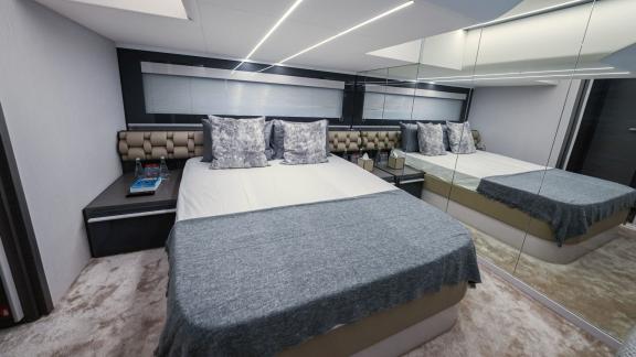 Pershing 5X White offers a modern and luxurious bedroom for an exclusive yacht rental experience in Dubai.