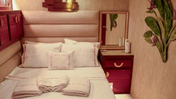 The guest cabin on Ayem offers cozy elegance for Göcek motor yacht charter guests.