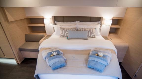 Master bedroom of the 7th Heaven catamaran in Athens, offering comfort and elegance.