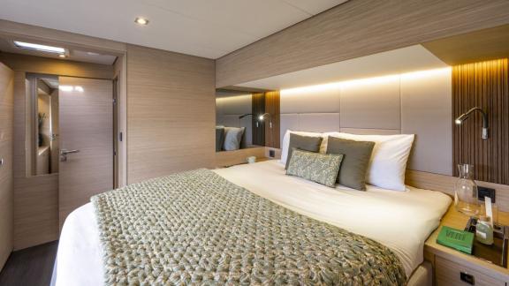 Die Kabine der Lady M bei Athen hat ein großes Bett, Leselampen und modernes Holzdesign.