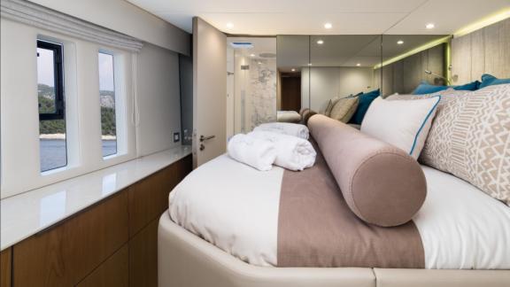 In Kastela Zara’s cabin has sea view windows a large bed and a door leading to the bathroom.