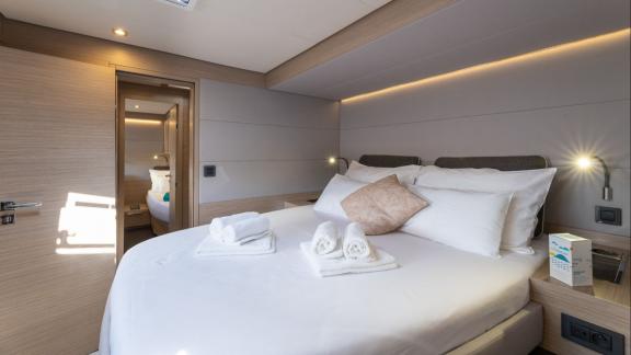 On the Lagoon 55 model catamaran Artisan, the guest cabin features ample windows and natural light for a tranquil stay.