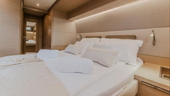 With modern lighting and elegant design, this bedroom provides a peaceful ambiance and restful sleep.