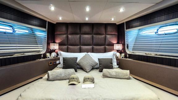 The double cabin on the Ammonite motor yacht features a spacious bed and modern decor.