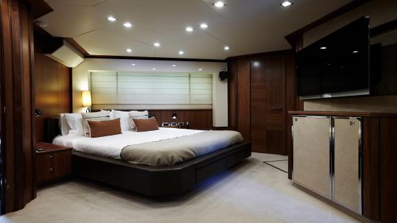 The luxurious master cabin of Um7 offers comfort with a spacious bed and modern decor.