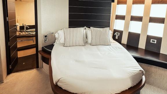 The bedroom on motor yacht Esperanza offers a cozy sleeping space with elegant decor and soft bedding.