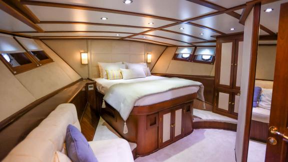 Gazella’s guest cabin features a large bed, a seating area, and spacious wardrobes.