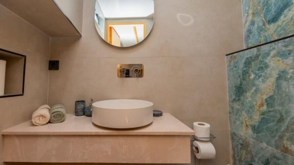 The bathroom of trawler yacht Kaan Bey 2 features a stylish sink and modern design.