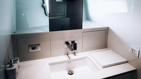 The sink area on motor yacht Coco De Mer provides a spacious feel with modern, minimalist design.