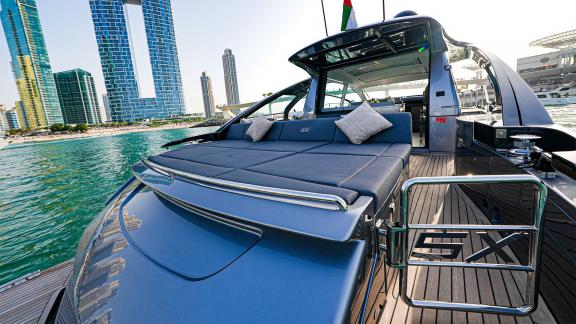 Enjoy delightful moments on the rear deck of Pershing 5X Grey with daily Dubai yacht rental options.