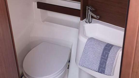 The compact bathroom of sailing yacht Okeanos in Athens offers a practical space during a sailing holiday.