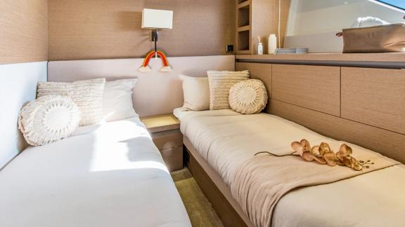 The twin cabin of Blue M yacht in Mallorca includes two single beds and cozy decor.