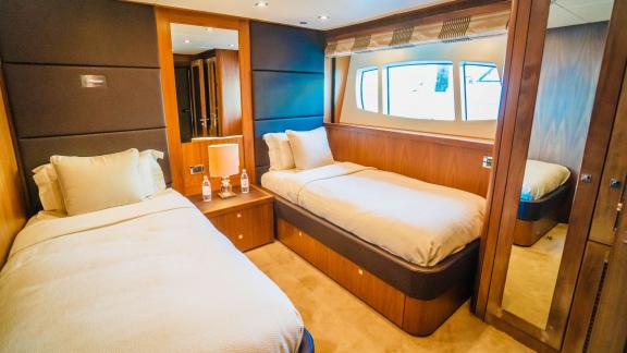 A cozy twin cabin on the Lucien motor yacht, perfect for your luxury yacht charter in Dubai.