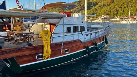 The Gulet Ahmet Ertürk stands out in this side view photo with its wooden hull and details.