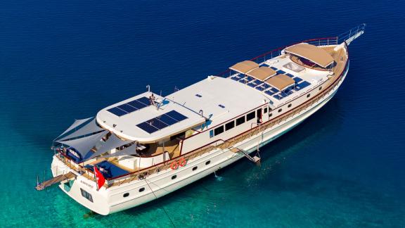 In Göcek gulet charter option Always Smile aerial view with sunbeds spacious deck and aft seating area visible.