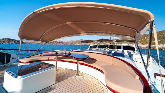 In Göcek gulet charter option Always Smile foredeck with shaded seating and relaxation area visible.