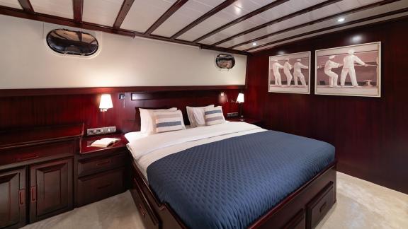 In Göcek gulet charter option Always Smile master cabin with large bed lighting and comfortable interior visible.