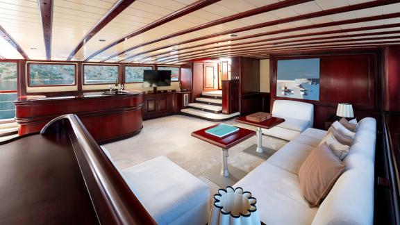 In Göcek gulet charter option Always Smile interior salon with seating area bar and panoramic windows visible.