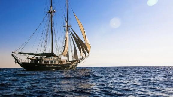 Gulet Arktos sailing on the sea with open sails.