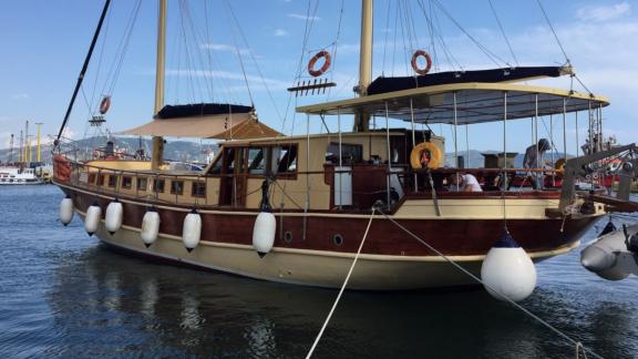 Gulet Aurora anchored at the harbor, ready for a comfortable journey with guests.