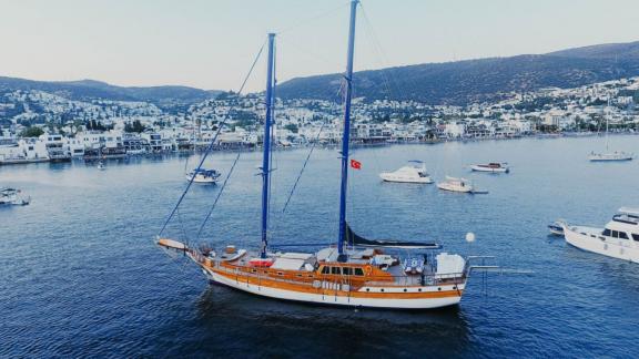 The gulet Barka is peacefully anchored in Bodrum bay, surrounded by other boats.