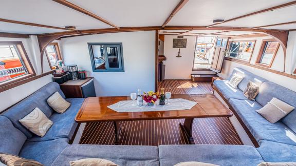 Cozy salon of the 22 meter Gulet Castiel with stylish interior and plenty of natural light.