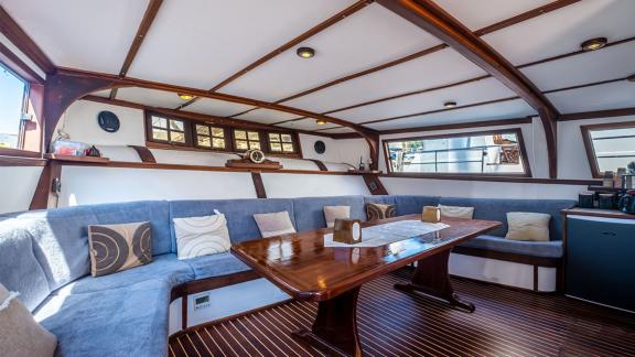 The stylish salon of the 22 meter Gulet Castiel offers cozy seating and a nautical ambiance.