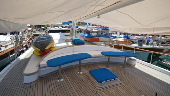 Seating area with blue and white cushions on the foredeck of Gulet Cemre 4.