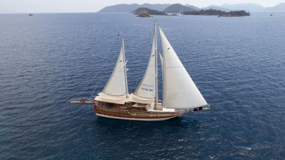 The Gulet Ceylan sailing by picturesque islands and clear waters near Fethiye, Turkey