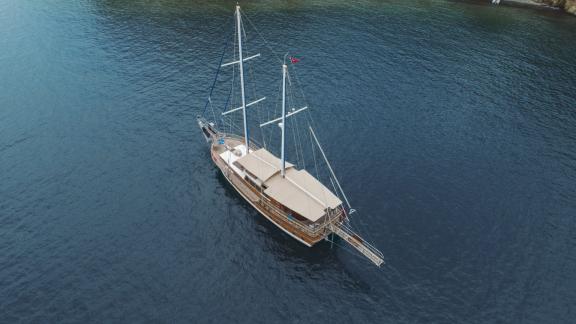 The Gulet Ceylan anchored in crystal clear waters of a calm bay near Fethiye