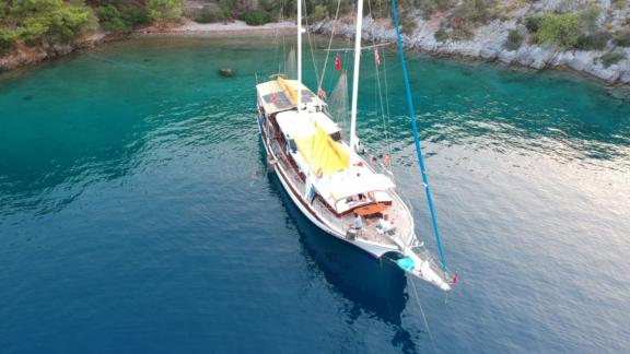 Gulet Cheers anchored in the crystal-clear waters of an idyllic bay in Fethiye.