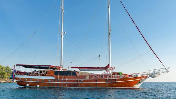 The gulet Croatia, with its wooden hull, is peacefully anchored in blue waters.