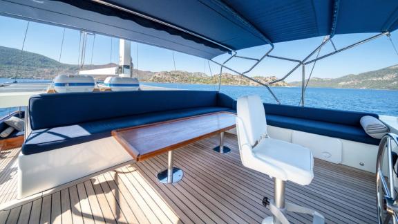 Flybridge seating area of the Deryam gulet in the bays of Bodrum, offering relaxation with panoramic views.