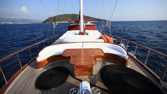 Spacious sun deck of the Gulet Doris with comfortable loungers and coastal views.