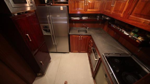 Well-equipped kitchen of the Gulet Doris with stainless steel appliances and wooden cabinets.