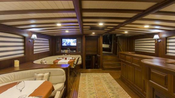 Elegant interior of a gulet with wood panelling.