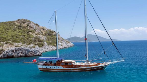 The five-cabin gulet Dulcinea is anchored in clear blue waters off the coast of Bodrum.