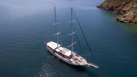 Luxurious gulet Duramaz with 6 cabins sails in clear, deep blue waters off the coast of Fethiye.