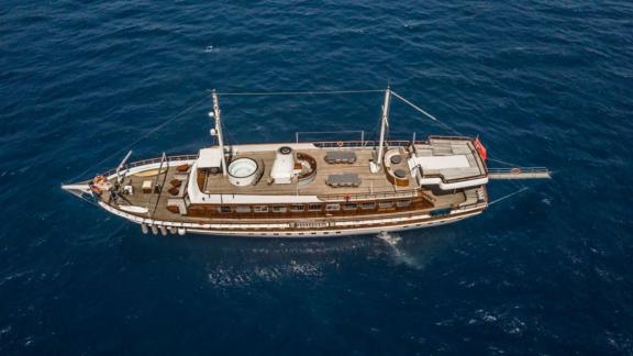 A bird's eye view of a large wooden sailing ship on the open sea