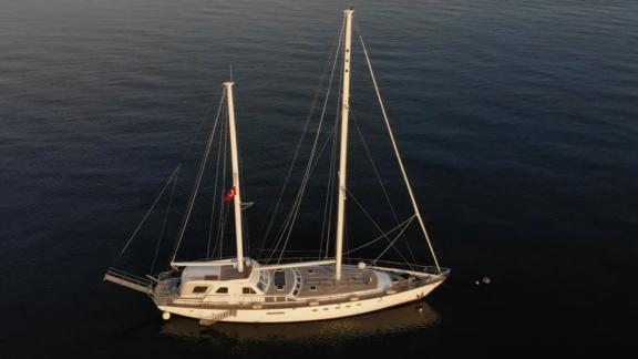 Among Marmaris yacht rental options Eloa is anchored in calm sea during sunset with peaceful atmosphere.